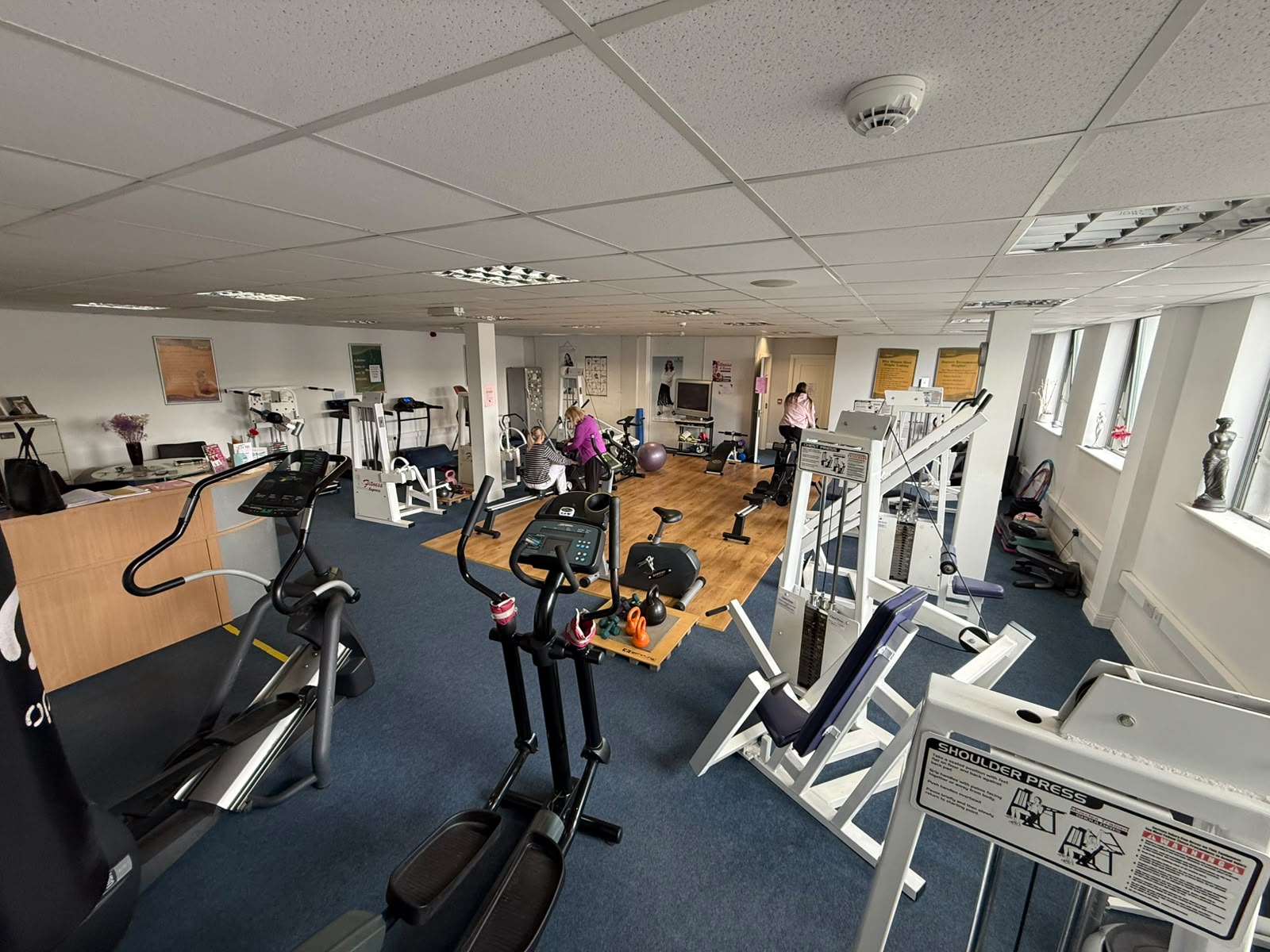 The Fitness Express gym floor with members training on cardio and resistance machines