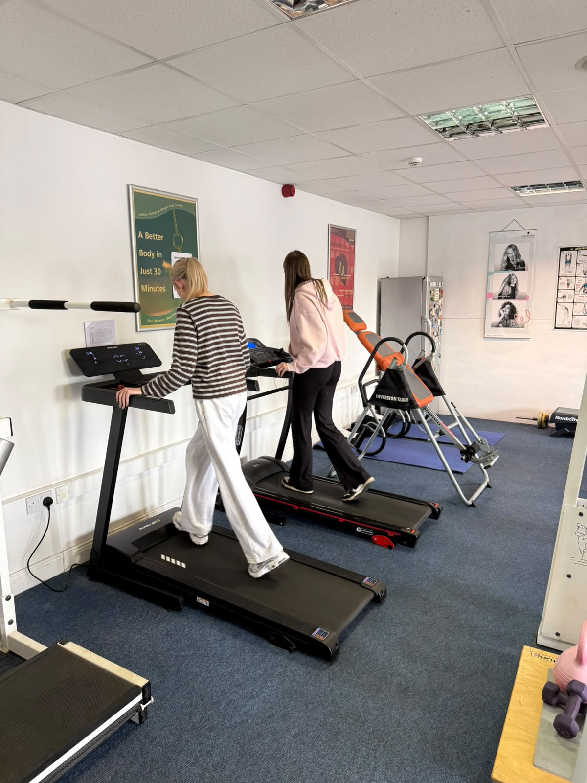 Two members walking on treadmills